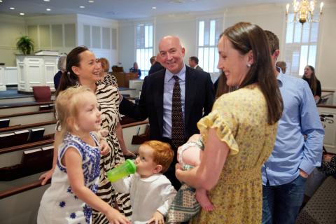 Families fellowshipping after the service